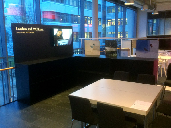 kleiner Messestand mit Regalen, Pr�sentern und schr�gem Podest